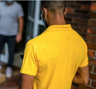 yellow shirt guy looking at tablet